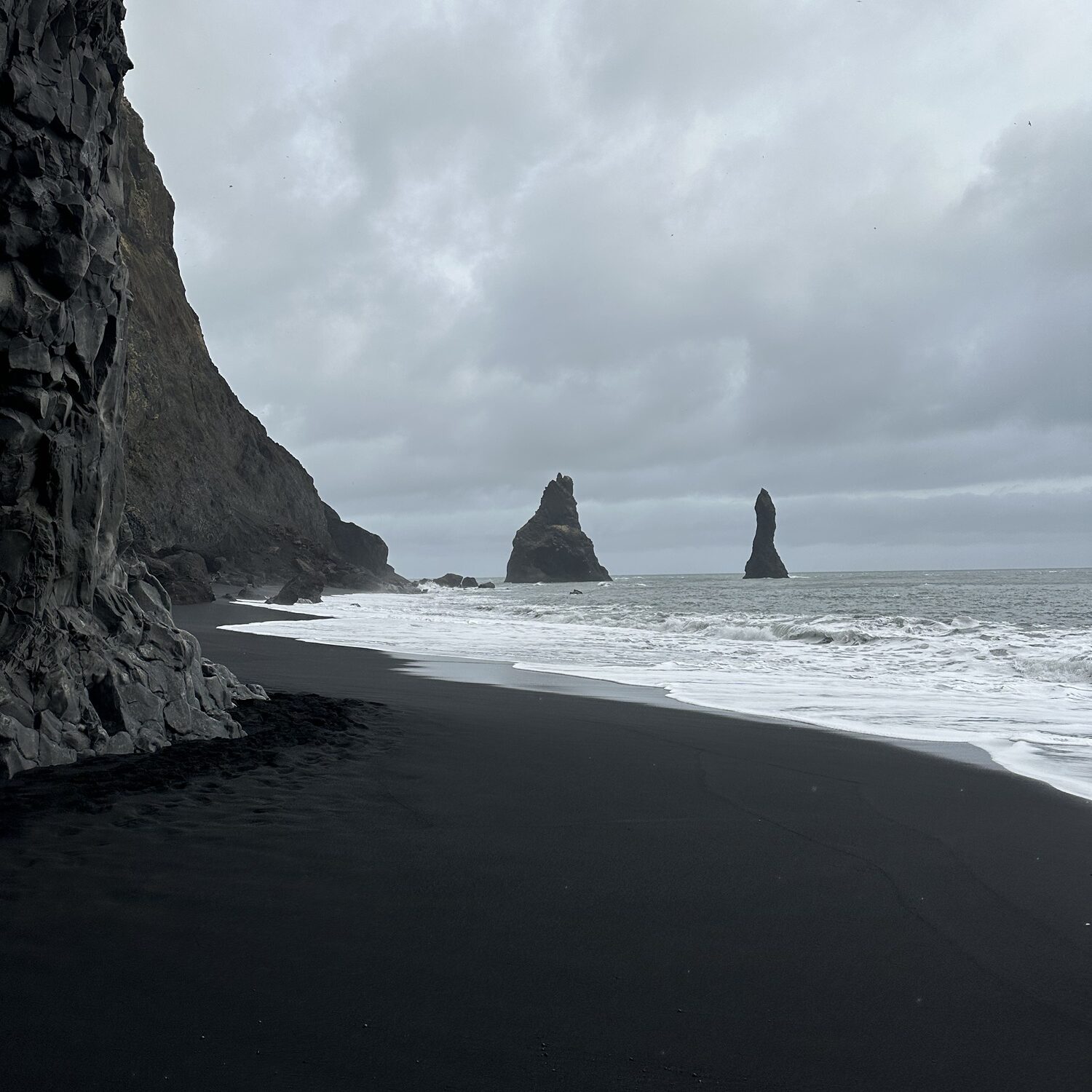 An image of Icelandic coastal landscape, with black volcanic sand.